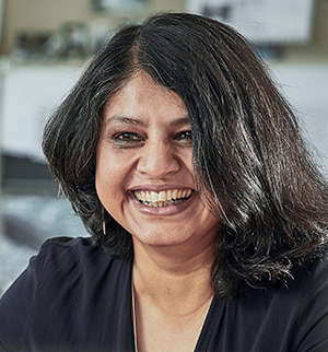 Headshot of Nandini Bagchee, looking to the left and smiling.