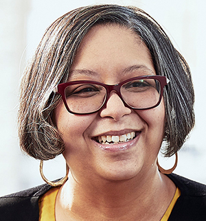 Headshot of Nilda Sanchez, smiling at the camera.