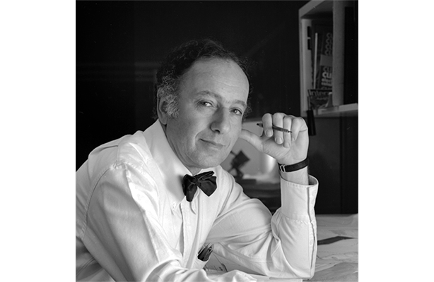 black and white photo: Harry Seidler at desk