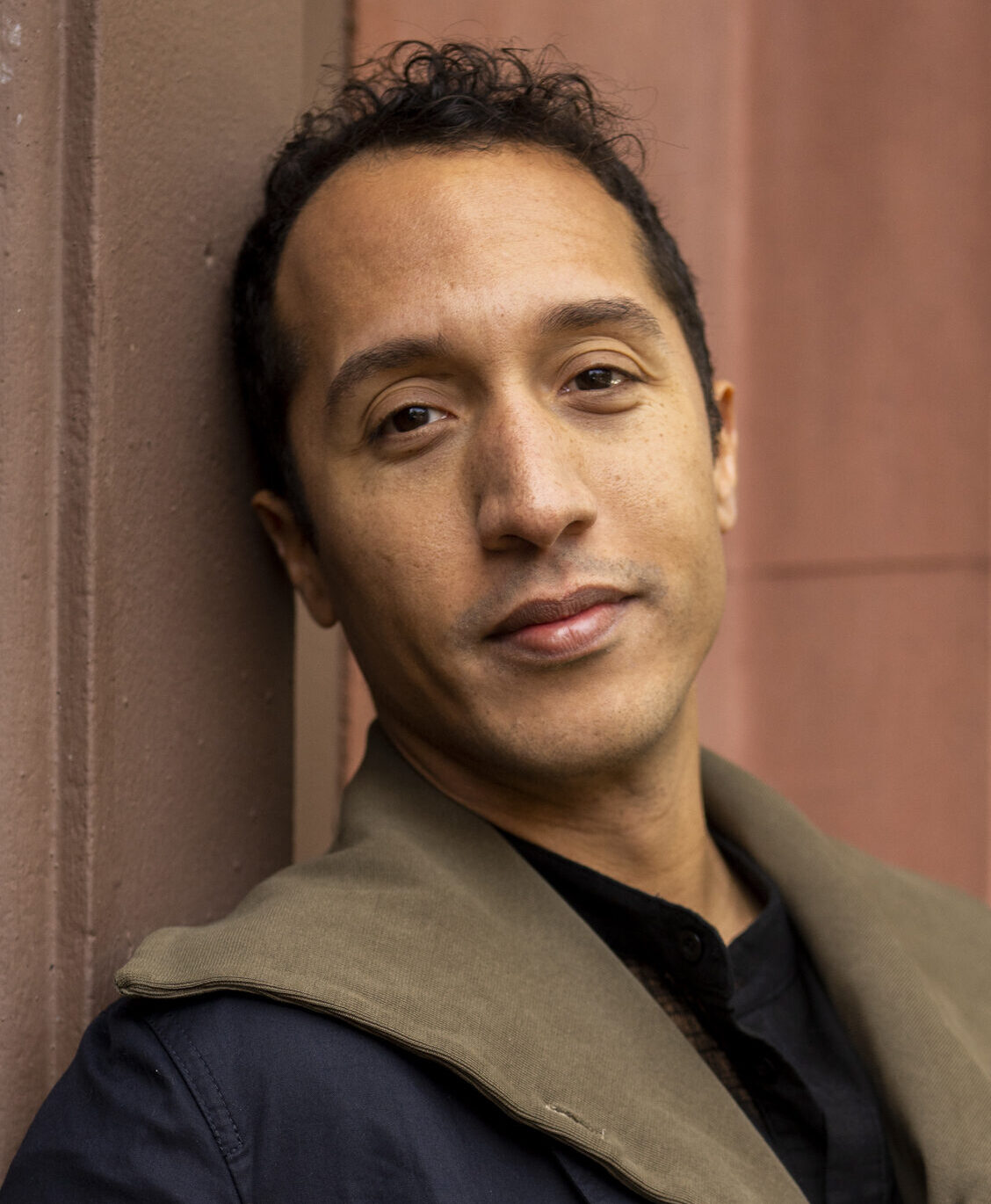 Headshot of Jerome Haferd, leaning against a wall and looking at the camera.