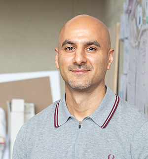 Headshot of Aurash Khawarzad, smiling at the camera.