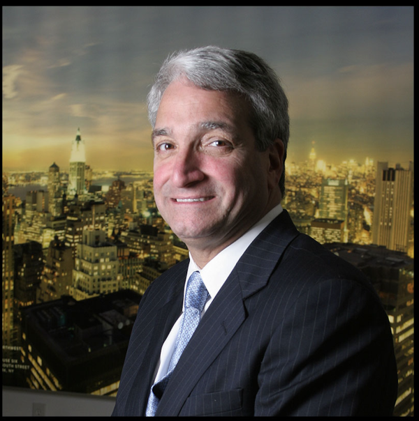 Headshot of Frank Sciame an alumnus of the Spitzer School of Architecture in front of NYC skyline.