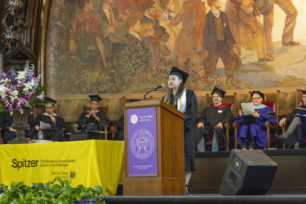 Amy Ho delivers her valedictorian address at the podium.