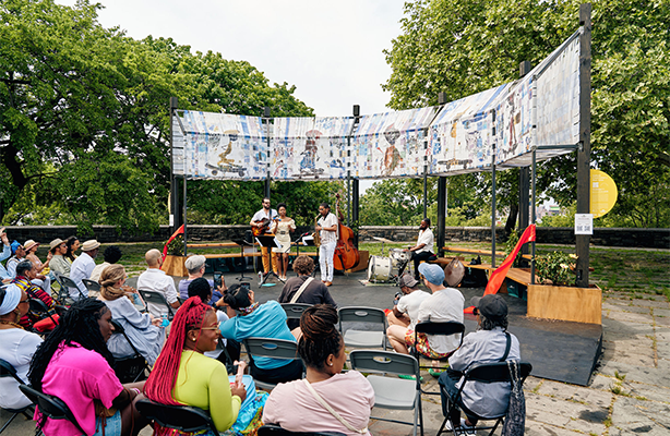 A group of people watching a performance at the Aleia installation