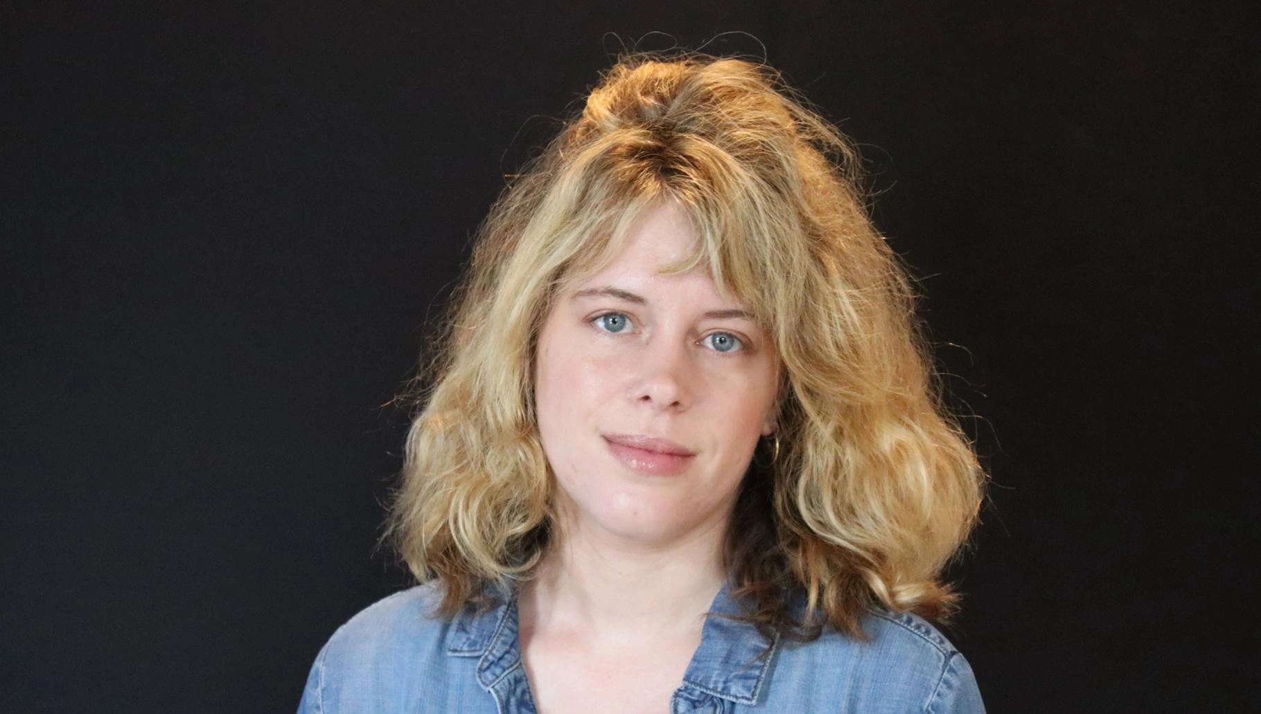 Headshot of Jessica Larson looking at the camera head slightly tilted to the right.