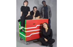 Students from the Freedom by Design posing with the mobile learning workstation. From left Evelyn Krutoy, Juan Giraldo, Mouhamadou Dieng, and Gildalis Torres (seated).