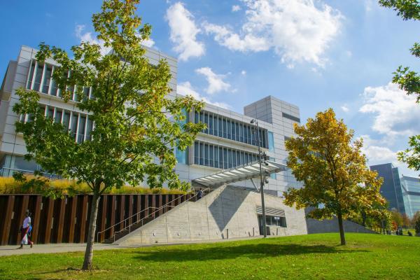 Photograph of the Spitzer School of Architecture behind two trees and a green lawn.