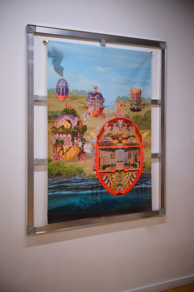Installation view of a large vertical art print mounted within an open rectangular aluminum display frame on a white gallery wall. The colorful, imaginative digital illustration depicts a speculative landscape filled with ornate, spherical traveling automata and mobile pavilions. In the foreground, an egg-shaped orange vessel is shown in cross-section at a body of water, revealing intricately detailed interior rooms, levels, and machinery extending both above ground and below the water line.